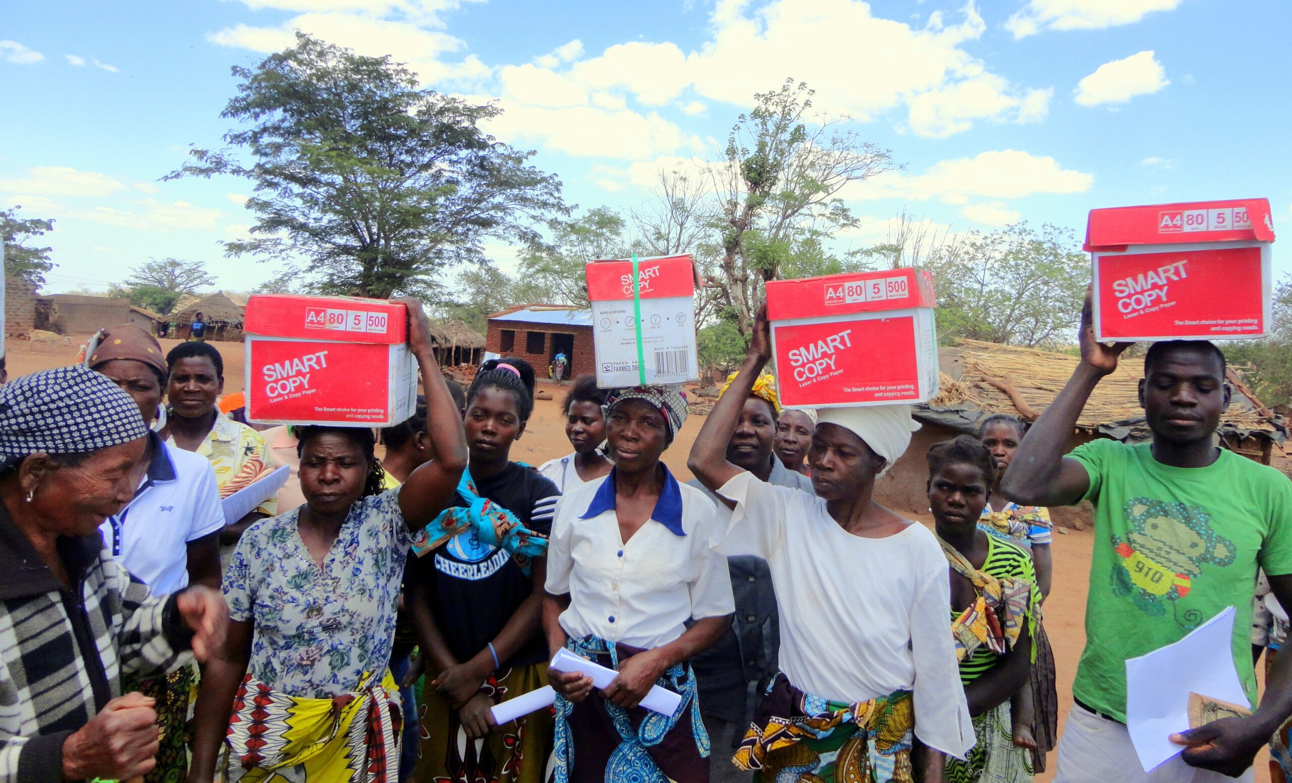 En grupp afrikaner bär kartoner med Matteusevangeliet på sina huvuden.
